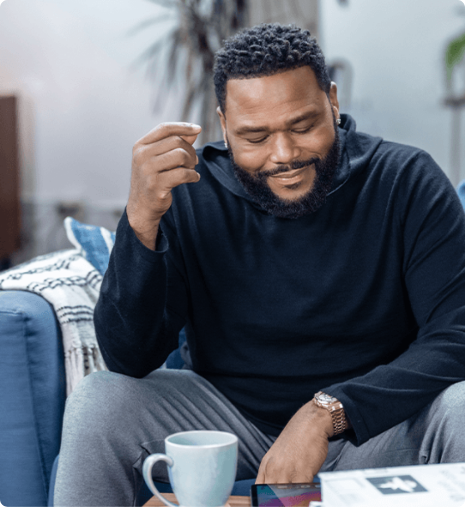 Anthony Anderson sitting on couch