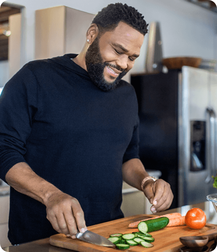 Anthony Anderson cooking in kitchen
